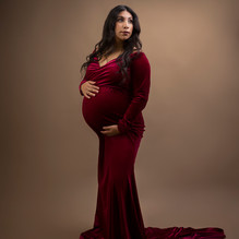 Pregnant woman with red dress and brown background. How do I choose a good photographer?